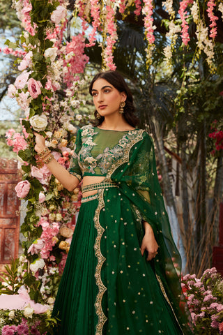 Forest green pleated lehenga with an organza embroidered blouse paired with an organza embroidered dupatta