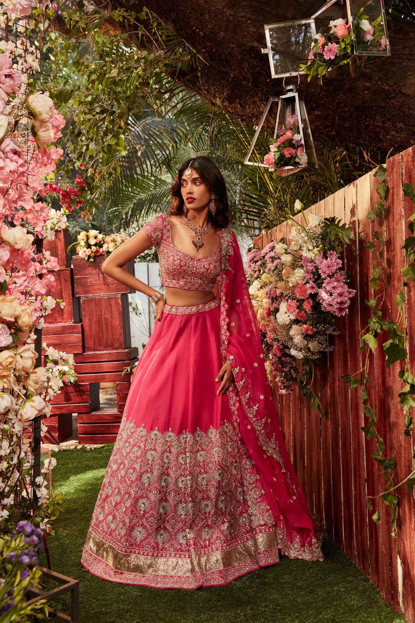 Hot pink raw silk embroidered lehenga with embroidered blouse paired with an organza dupatta