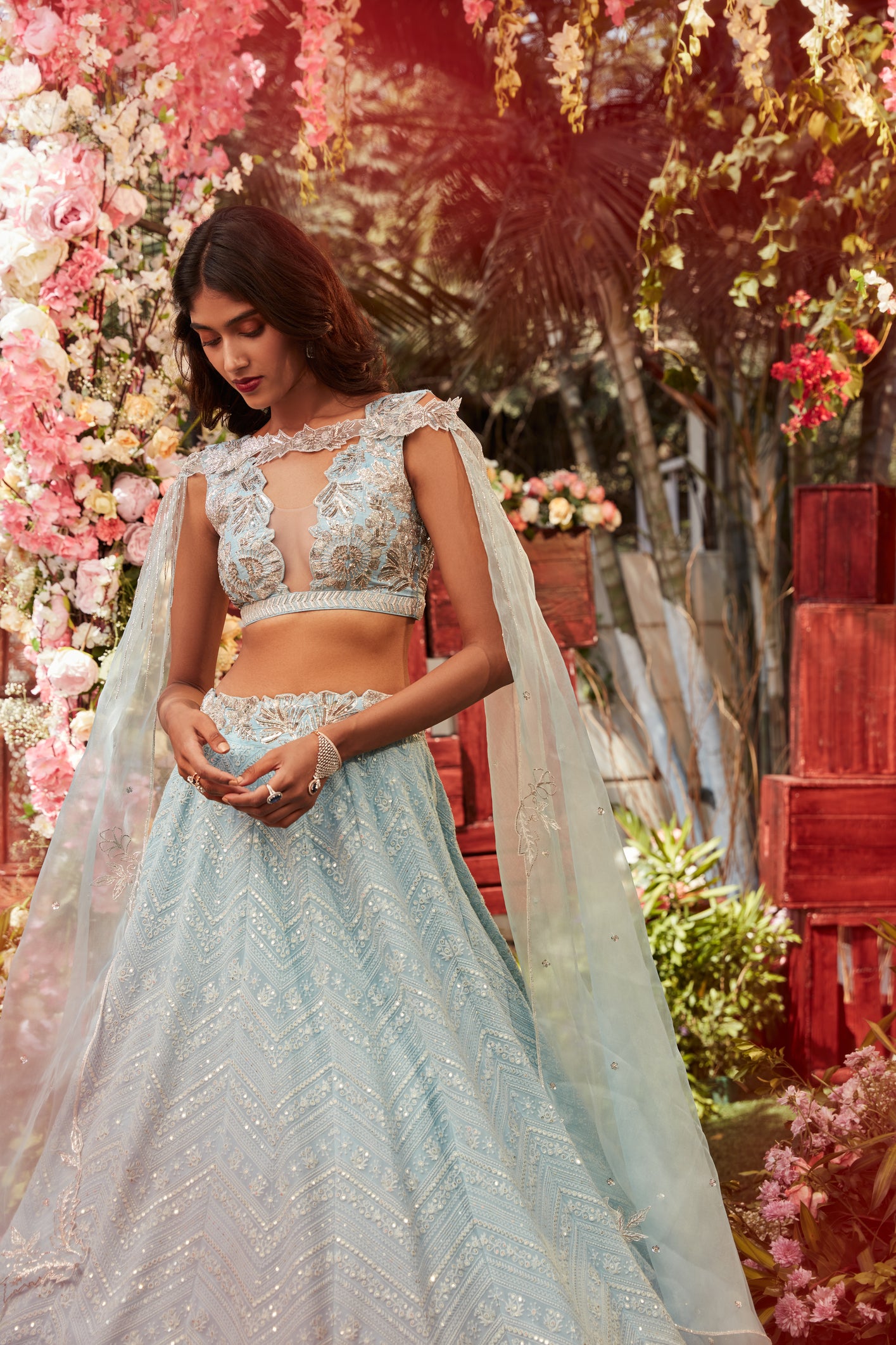Ice blue chikankari lehenga with raw silk embroidered paired with an embroidered organza cape
